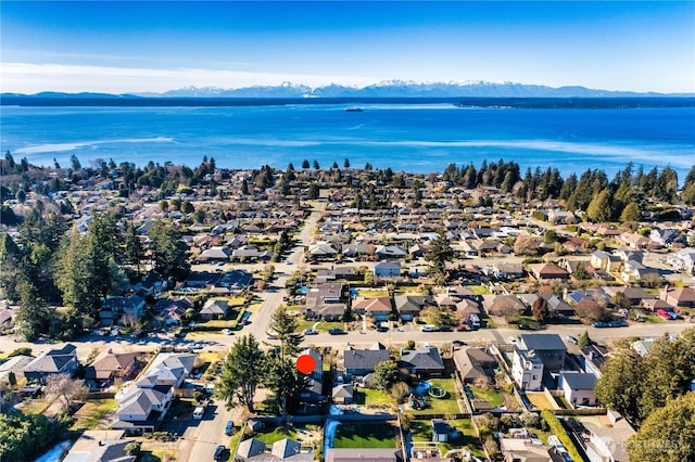 birds eye view of property with a water and mountain view