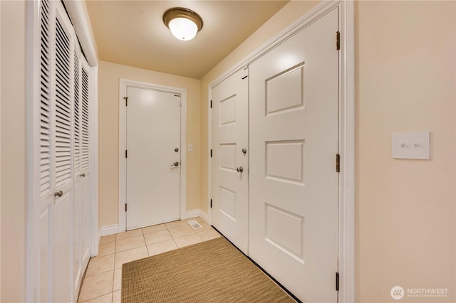 doorway to outside featuring light tile patterned floors