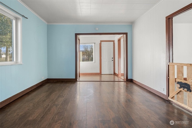 unfurnished room featuring ornamental molding, dark wood-style flooring, and baseboards