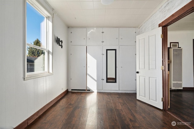 unfurnished room with dark wood finished floors