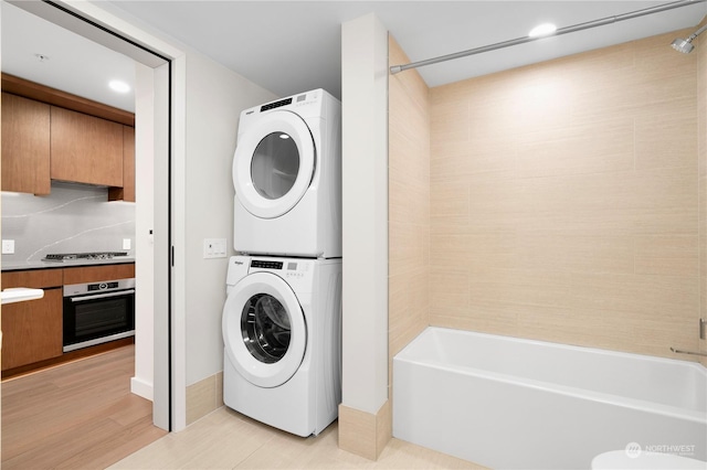 laundry room with stacked washer / dryer