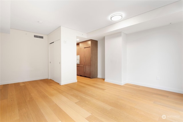 empty room with hardwood / wood-style flooring