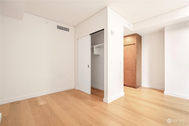 unfurnished bedroom featuring light wood-type flooring