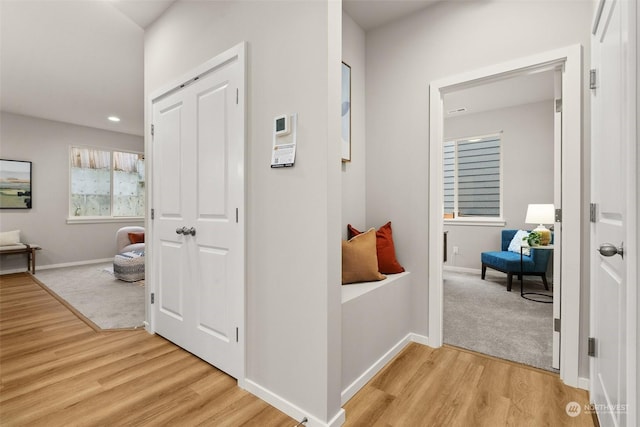 corridor with light hardwood / wood-style flooring