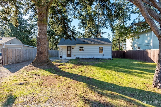 exterior space with a front lawn and a fenced backyard