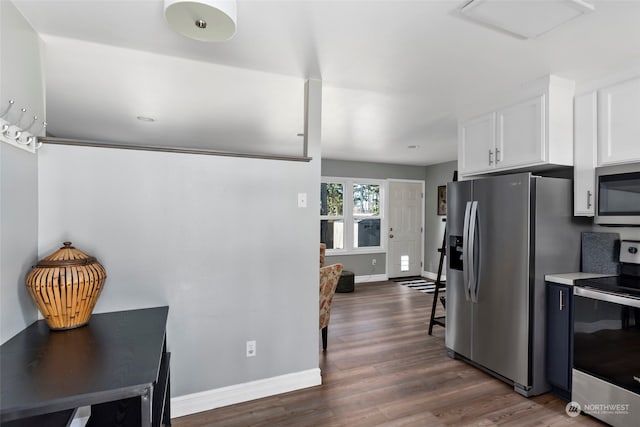 kitchen featuring baseboards, appliances with stainless steel finishes, dark wood-style flooring, light countertops, and white cabinetry