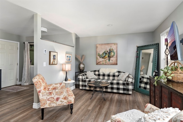 living area featuring baseboards and wood finished floors