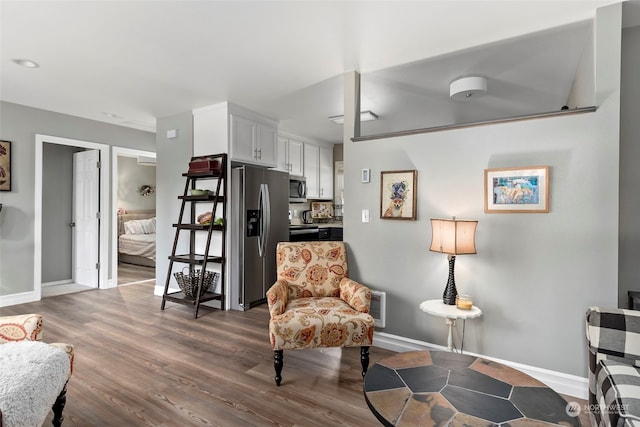 living area featuring dark wood finished floors and baseboards