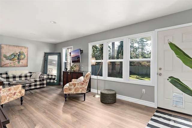 sitting room featuring baseboards and wood finished floors