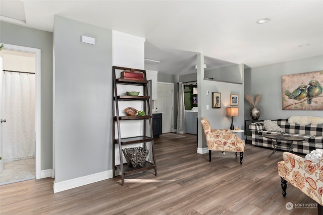 living area featuring baseboards and wood finished floors