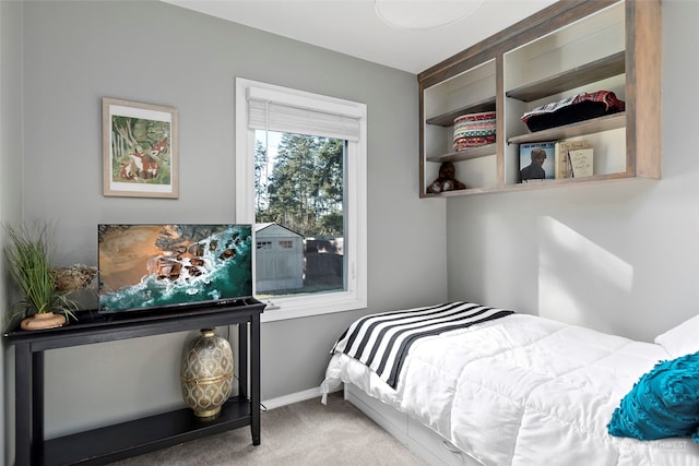 bedroom with carpet floors and baseboards