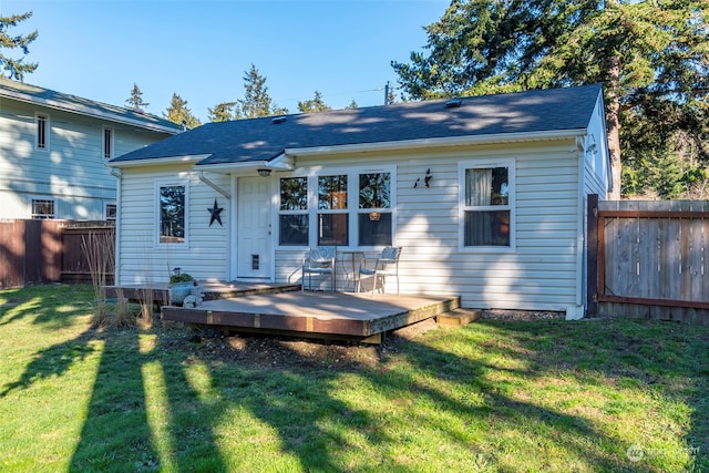 back of house with a lawn, a fenced backyard, and a wooden deck