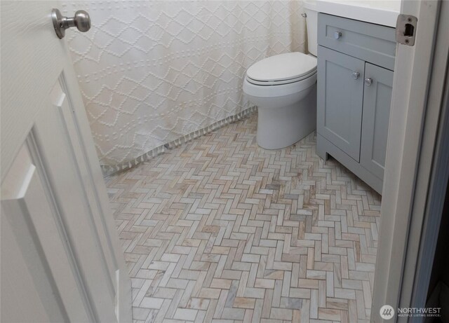 bathroom featuring toilet and vanity