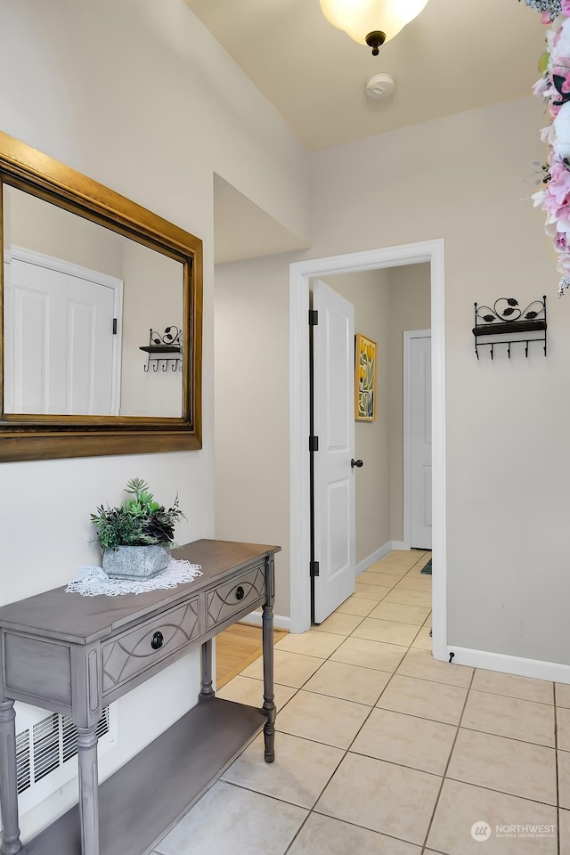 corridor featuring light tile patterned floors