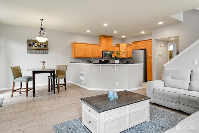 living room with light hardwood / wood-style flooring