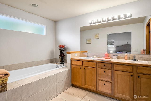 bathroom featuring tile patterned flooring, vanity, tiled bath, and backsplash