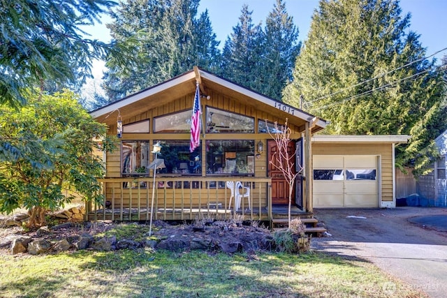 view of front of home featuring an outbuilding, driveway, and an attached garage