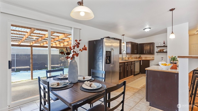 dining space with sink and light tile patterned floors