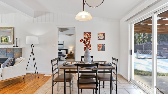 dining space with lofted ceiling and light hardwood / wood-style floors