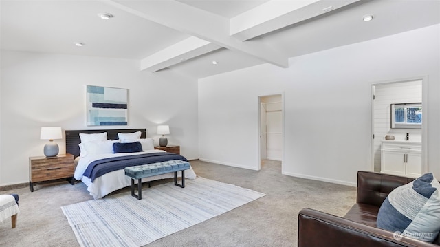 carpeted bedroom with vaulted ceiling with beams and ensuite bath