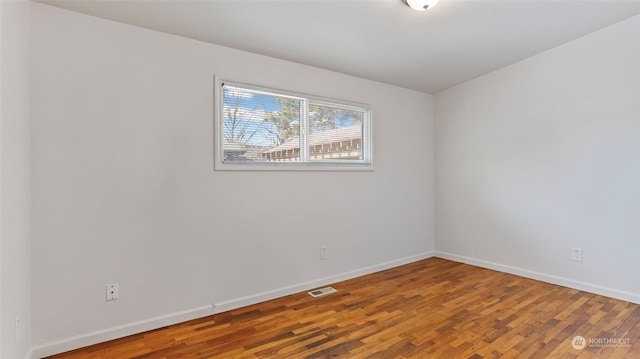 spare room with hardwood / wood-style floors