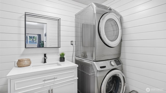 27223 154th Ave SE, Kent, WA 98042 - laundry room with stacked washer / drying machine, cabinet space, and wood walls
