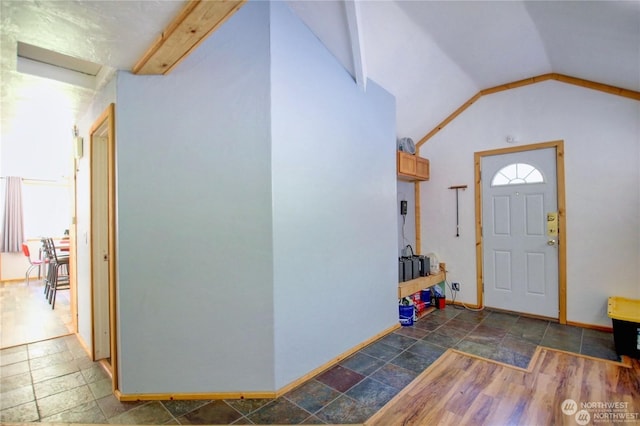 entrance foyer with vaulted ceiling