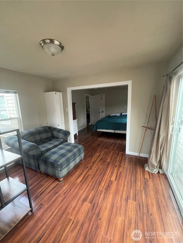 bedroom featuring dark wood finished floors and baseboards