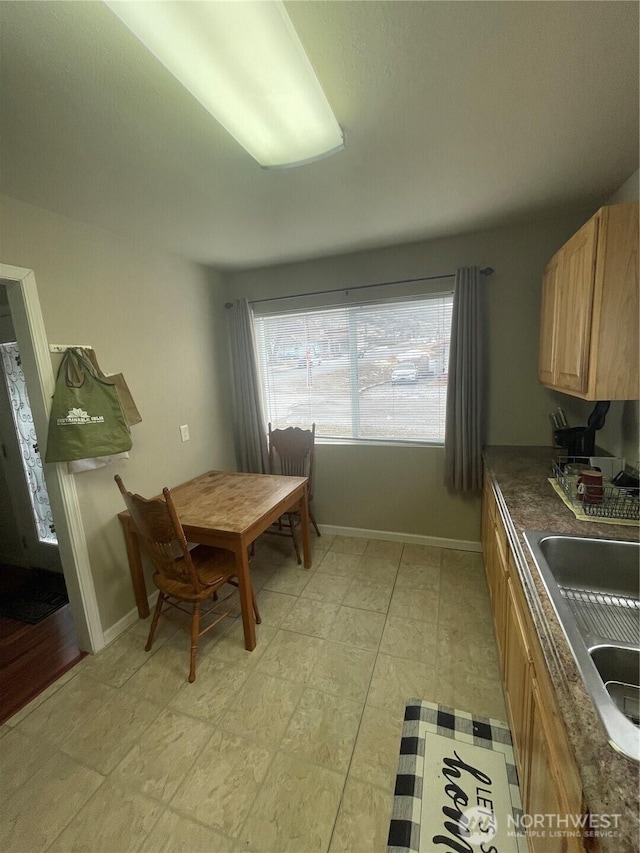 dining space featuring baseboards