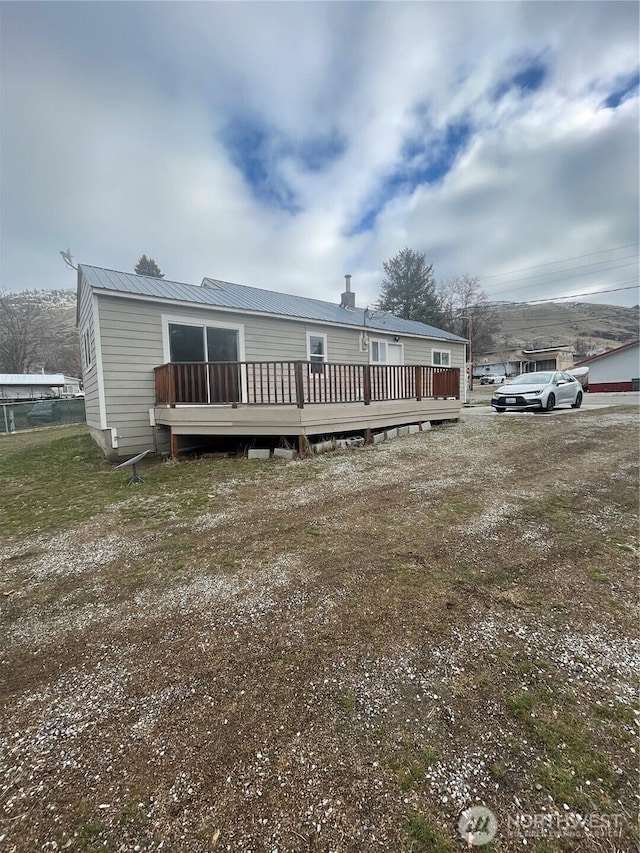 manufactured / mobile home featuring metal roof and a wooden deck