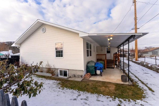 view of snowy exterior featuring fence