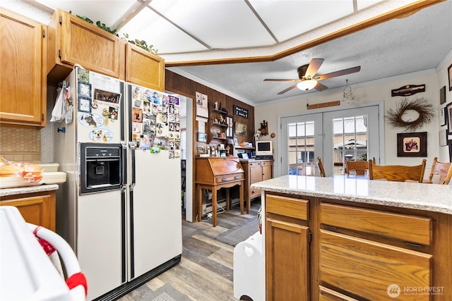 kitchen featuring light wood finished floors, white refrigerator with ice dispenser, ceiling fan, a textured ceiling, and french doors