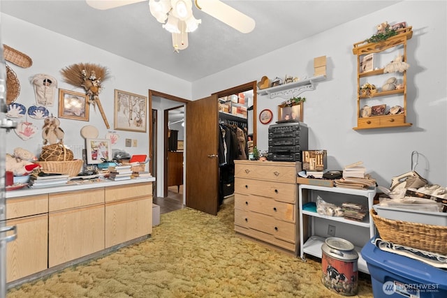 interior space with ceiling fan and light colored carpet