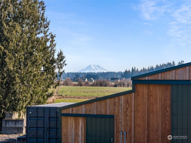 view of gate with a mountain view and an outbuilding