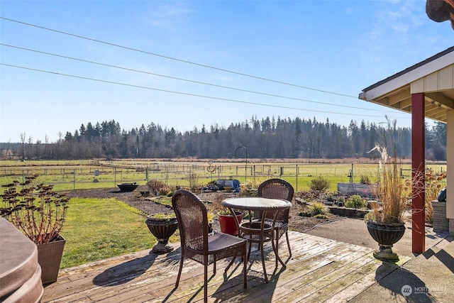 deck with a lawn and a rural view