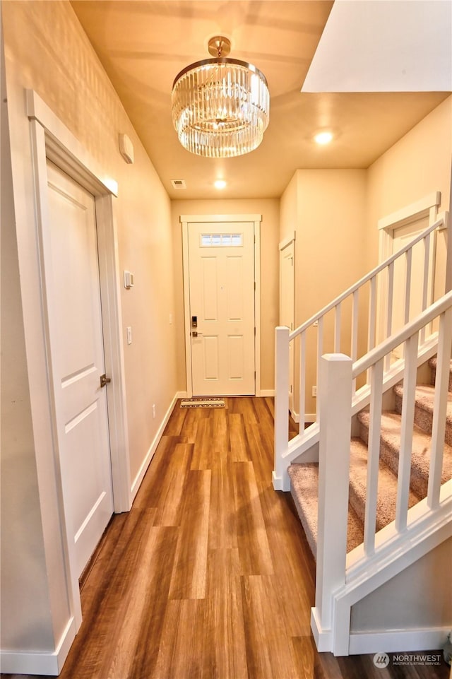 interior space featuring hardwood / wood-style floors and a chandelier