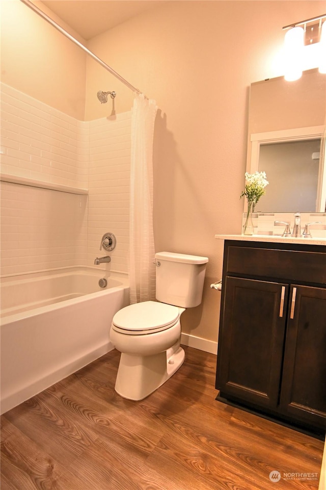 full bathroom with hardwood / wood-style flooring, vanity, toilet, and shower / bath combo with shower curtain