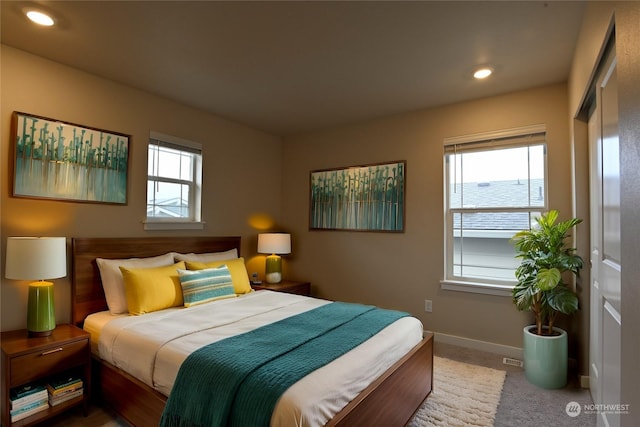 carpeted bedroom featuring multiple windows