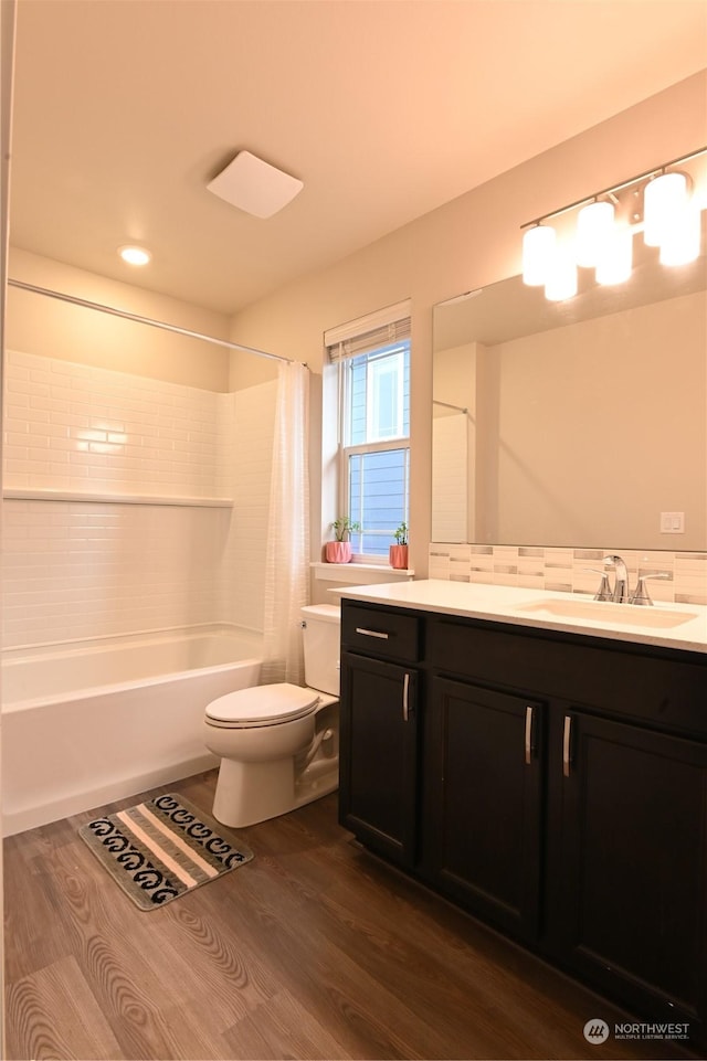 full bathroom with vanity, hardwood / wood-style flooring, toilet, and shower / bath combo