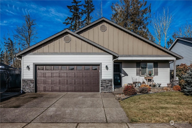 view of front of property with a garage and a front lawn