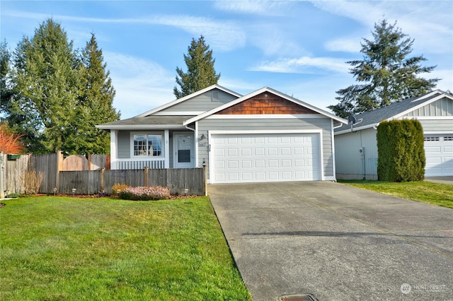 view of front of property with a garage and a front lawn