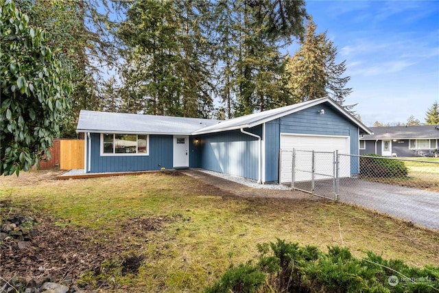 ranch-style home with a garage and a front yard