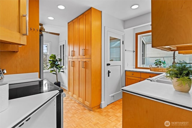 kitchen featuring recessed lighting, light countertops, and electric stove