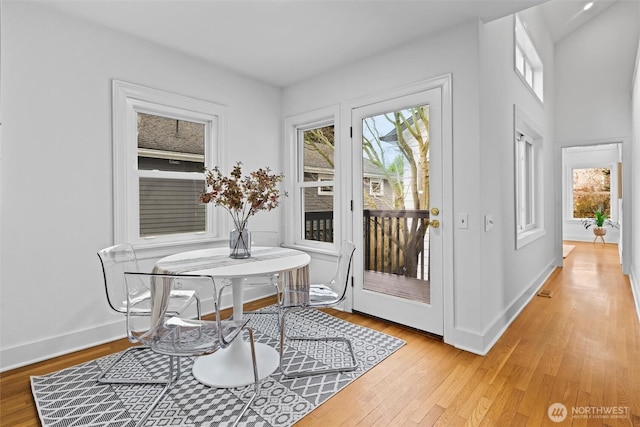 dining room with light wood-style floors and baseboards