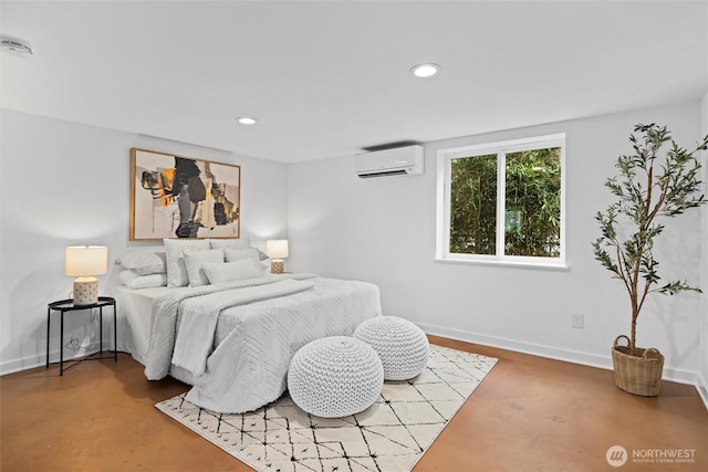 bedroom with recessed lighting, baseboards, finished concrete flooring, and a wall mounted AC