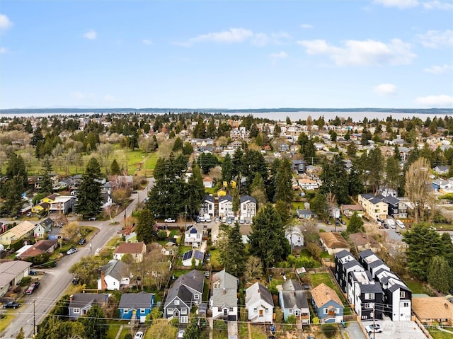 drone / aerial view featuring a residential view and a water view