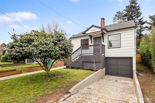 view of front of property with a front yard, driveway, a vegetable garden, an attached garage, and a chimney