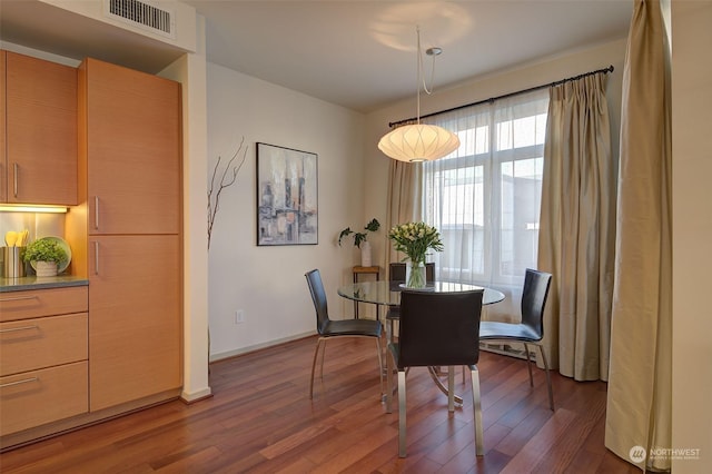 dining area with dark wood-type flooring