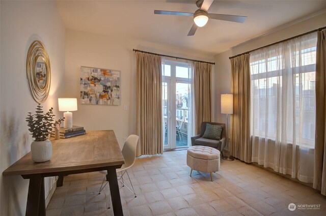 sitting room featuring plenty of natural light and ceiling fan