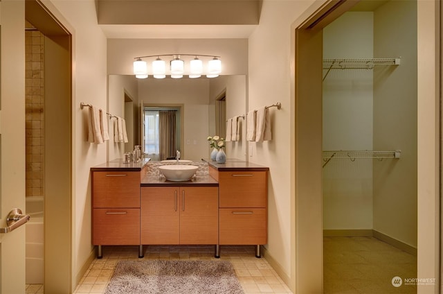 bathroom with vanity and a tub